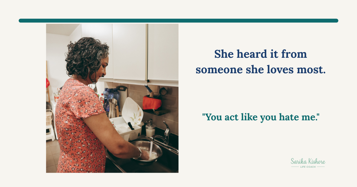 Sarika Kishore standing at her kitchen sink, washing dishes.
