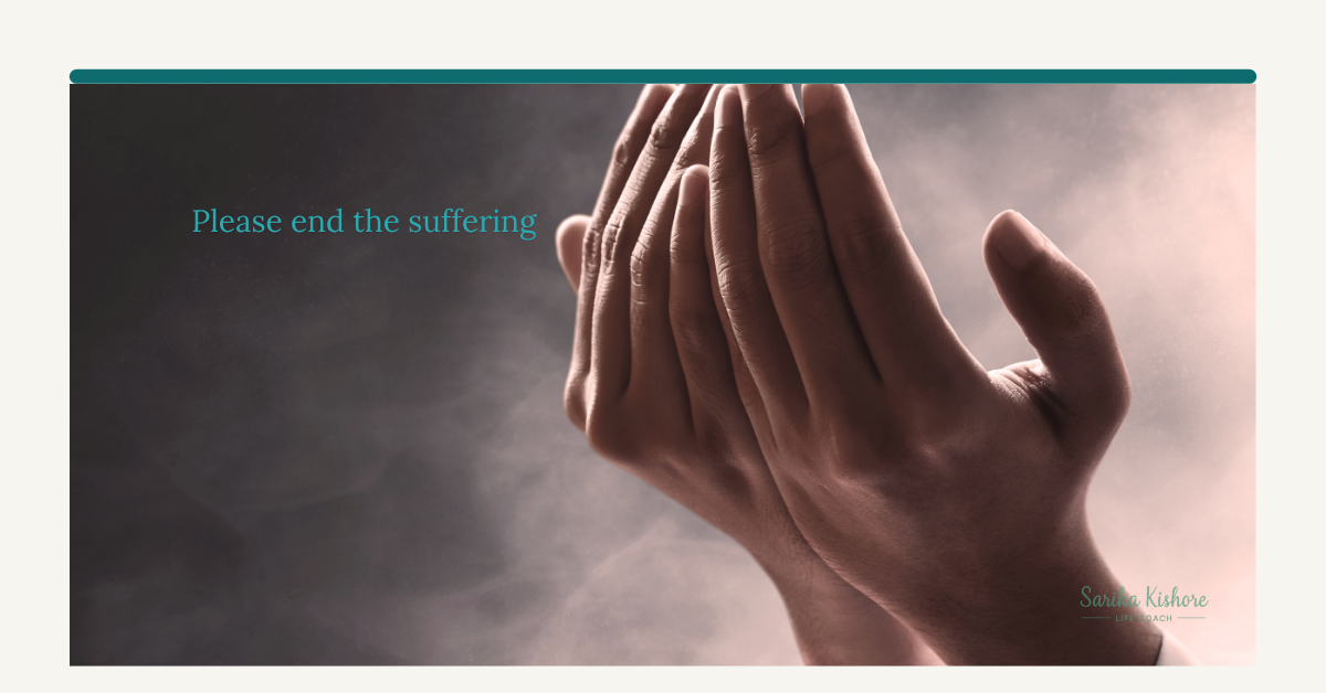 Hands pressed together in prayer, lit by soft light, at a parent's hospice bedside.